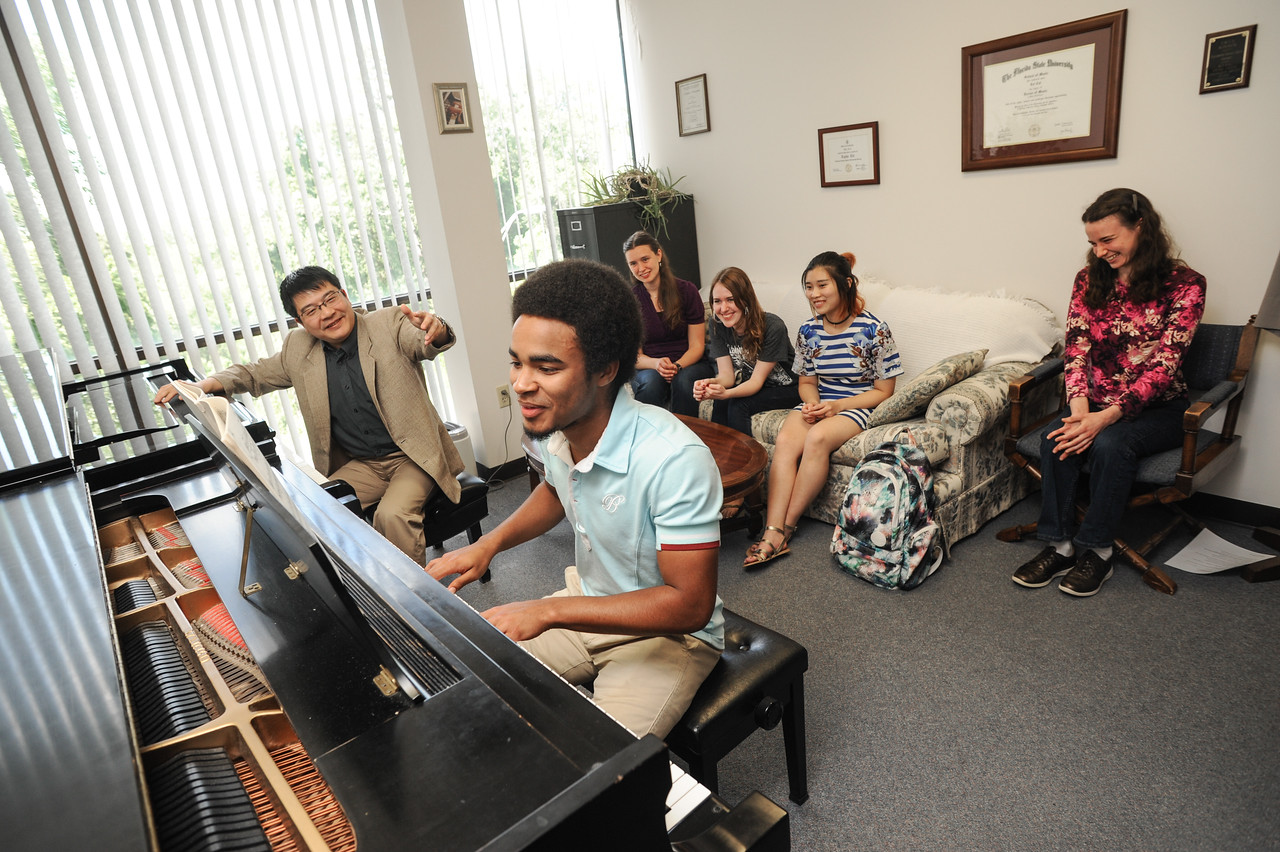 Dr. Lei Cai instructing piano student