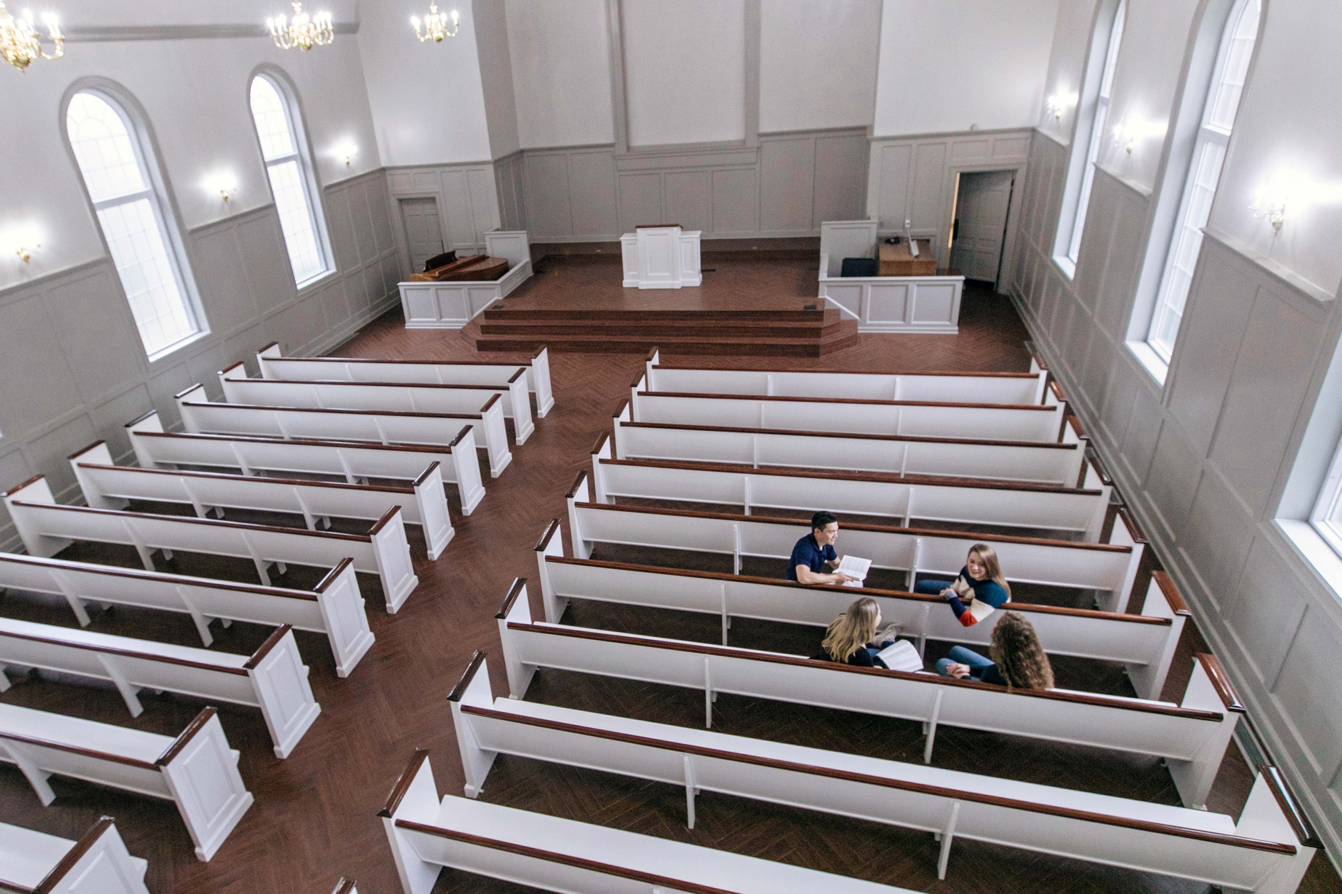 Students reading bible in chapel