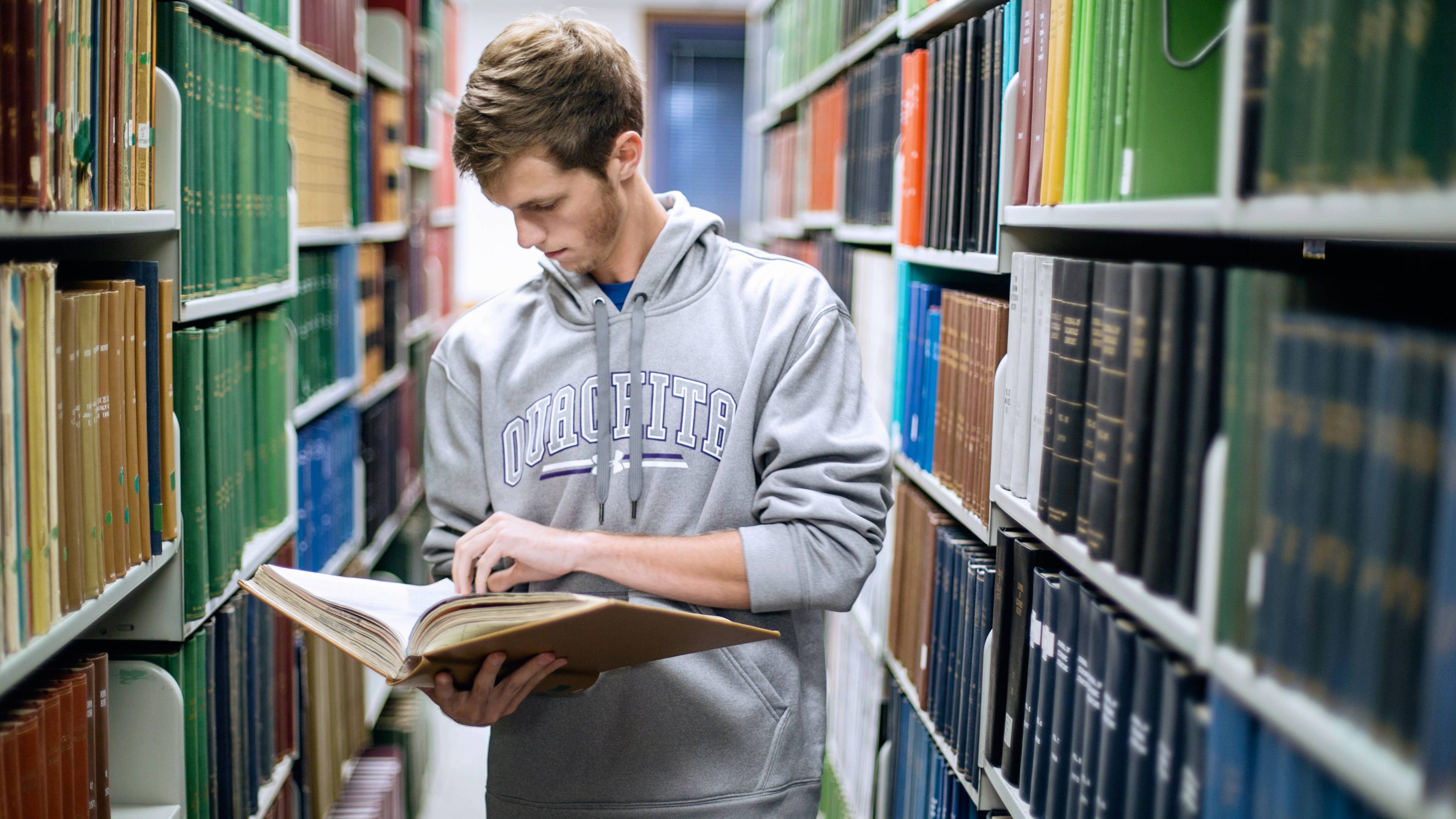 Student reading in library